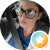 Heather, Google reviewer, smiling behind the wheel of her car