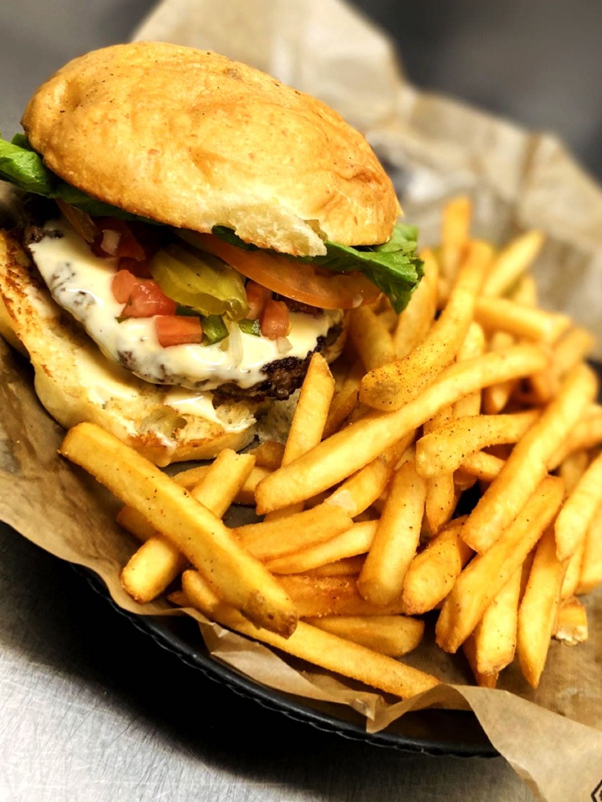 Cheeseburger topped with pico de gallo and jalapeños, served with french fries
