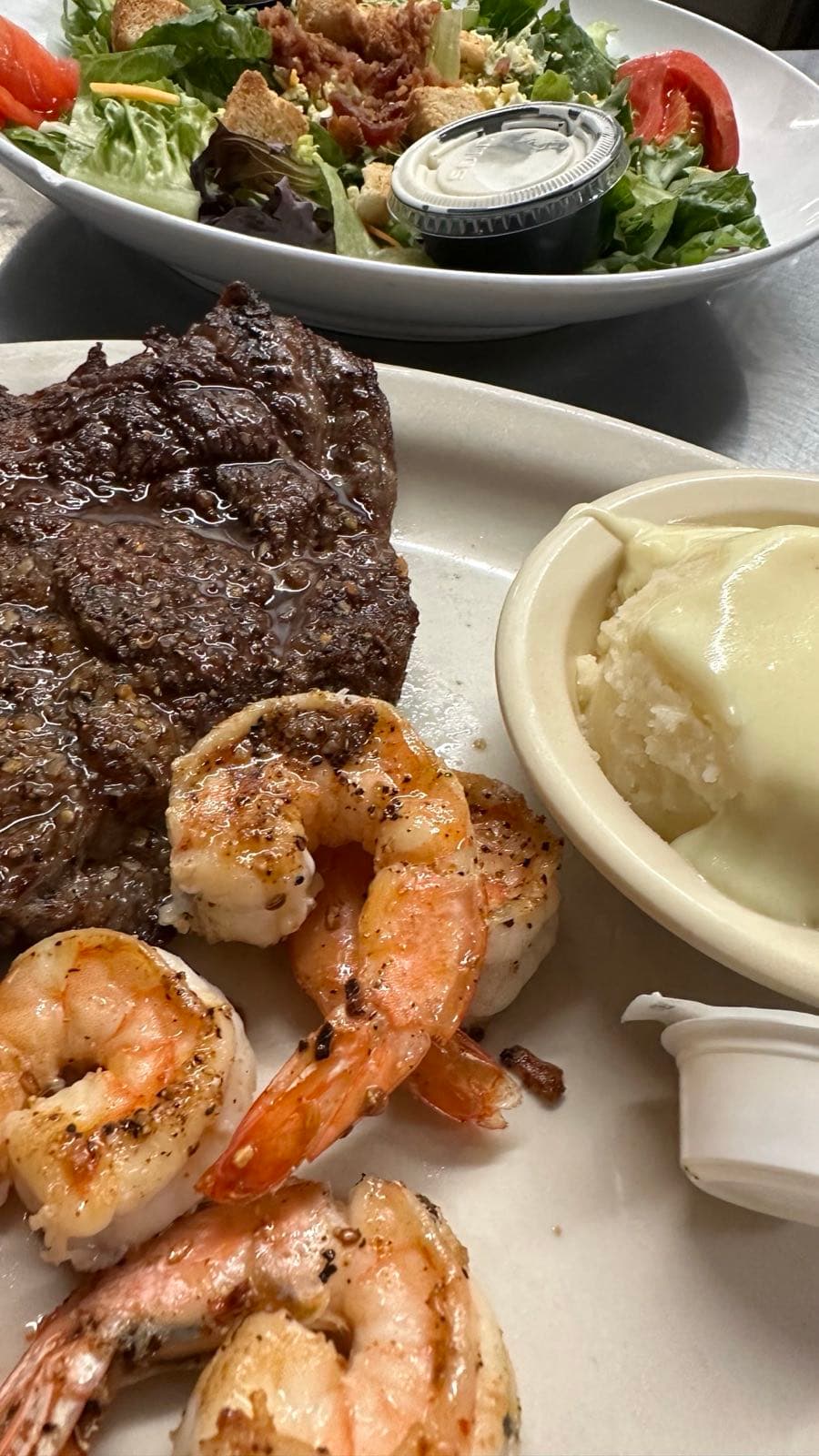 Grilled ribeye steak with jumbo shrimp and mashed potatoes, a surf and turf plate