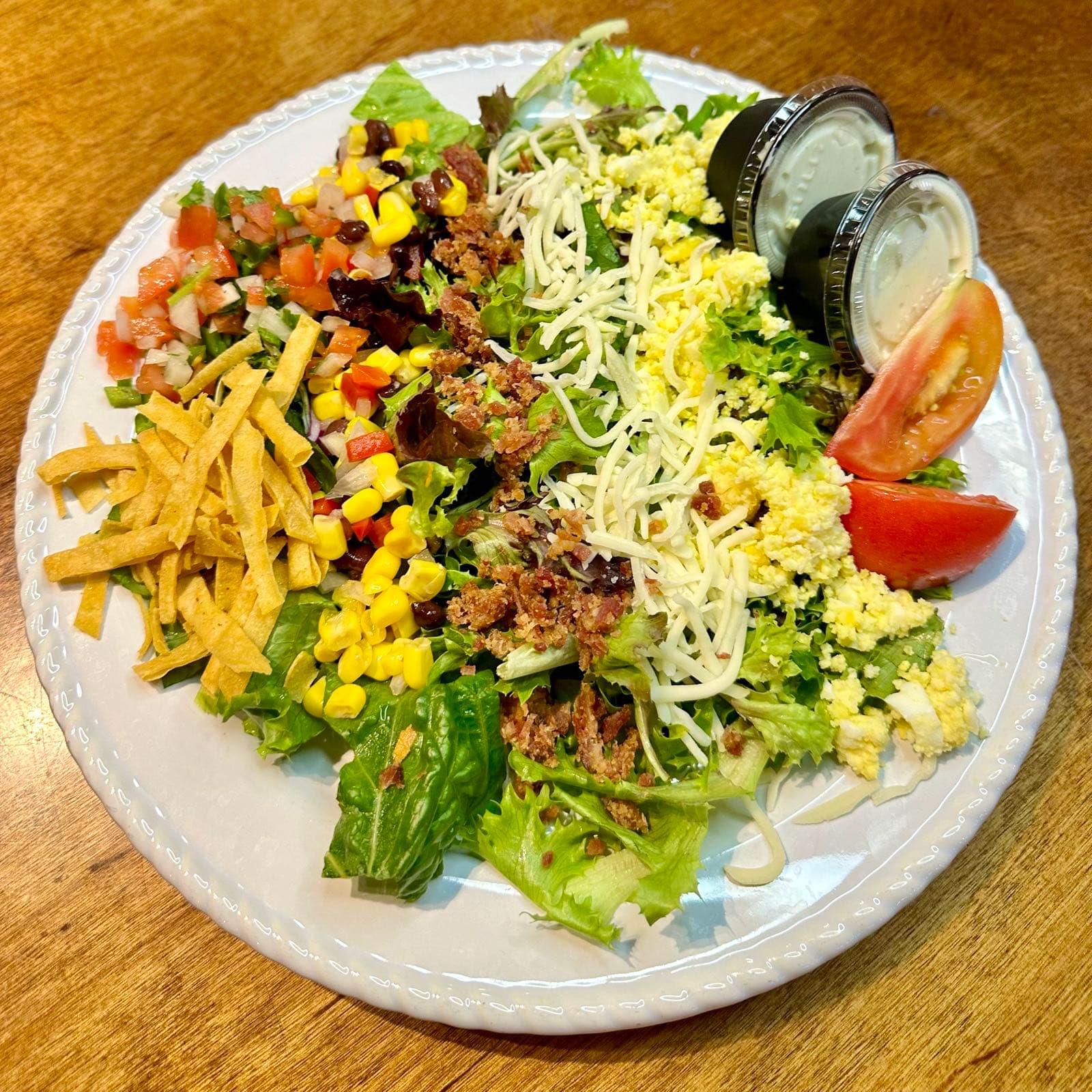 Southwestern cobb salad with black beans, corn, pico de gallo, bacon and cheese