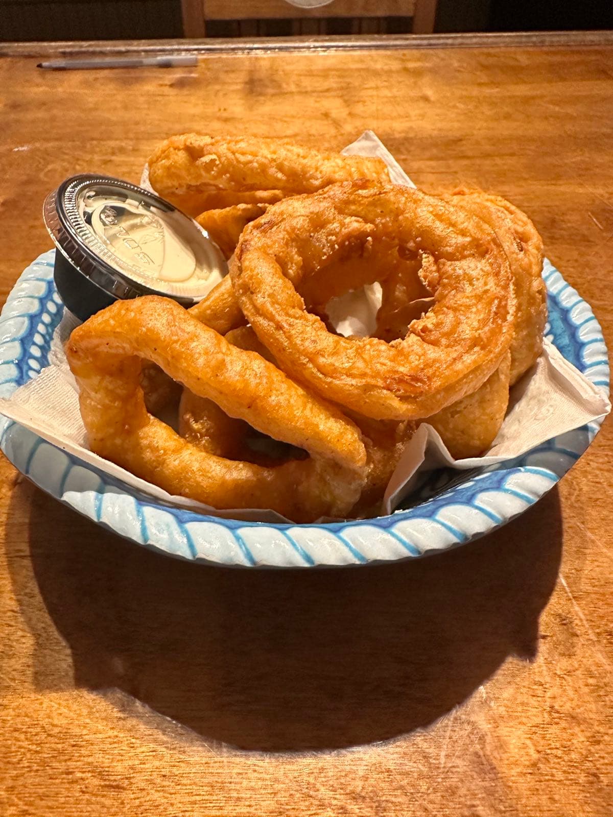 Basket of fried onion rings and battered jalapeño strips with ranch