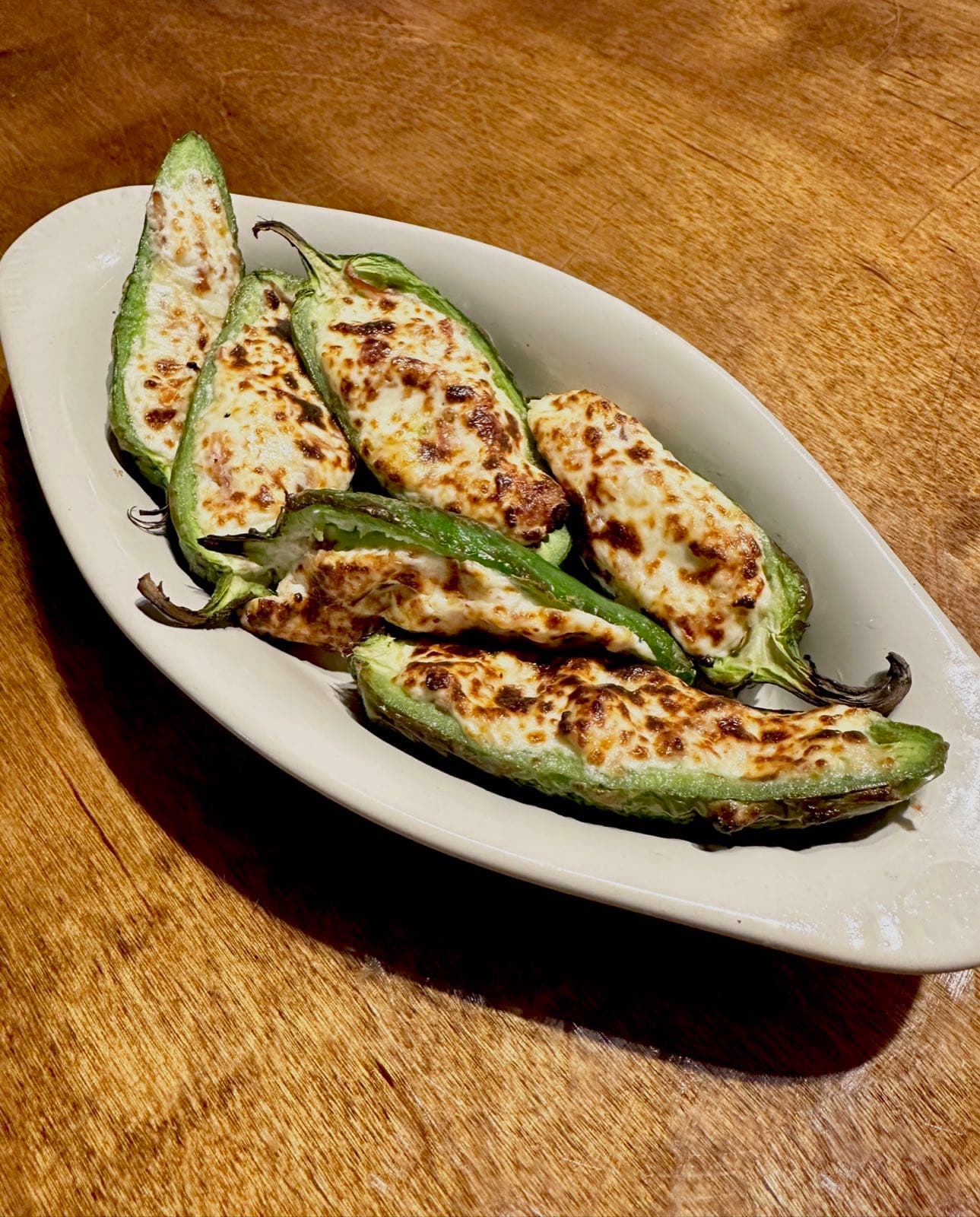 Cheese-stuffed jalapeño halves broiled until golden and bubbly