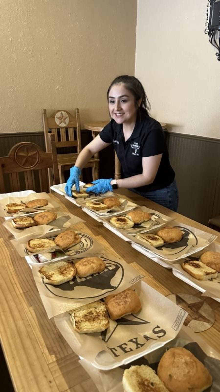 Texas Traditions staff boxing up biscuit sandwiches for a group order