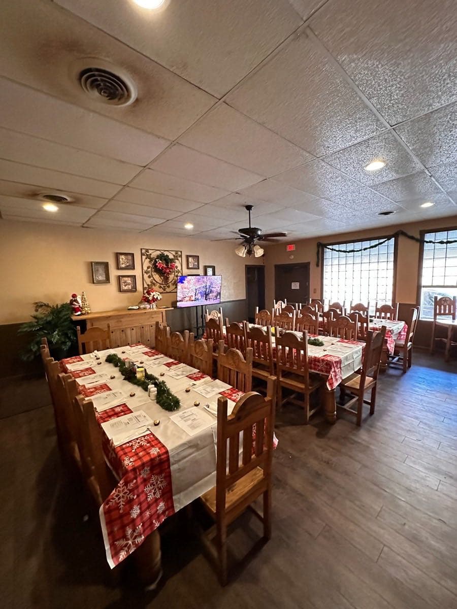 The party room set for a group event, seating along the windows.